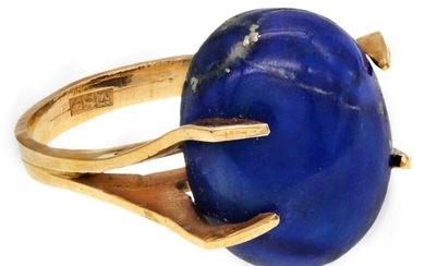 A Lapis Lazuli Gold Ring circa 1970 The oval cabochon lapis lazuli mounted in claw-set bifurica...