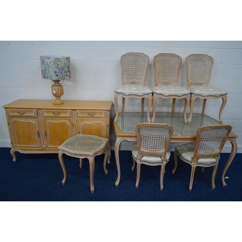 A MODERN BLEACHED WOOD FRENCH DINING SUITE, with wicker work...