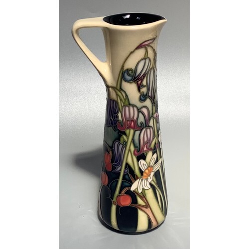 A Moorcroft pottery slender jug in the 'Wild Meadow' pattern...