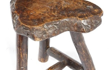A PRIMITIVE ELM DAIRY STOOL PROBABLY 19TH CENTURY...