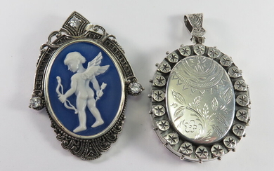A SILVER LOCKET AND A SILVER-FRAMED PUTTI PENDANT