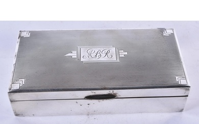 A Silver Cigarette Box with Engine Turned Decoration and woo...