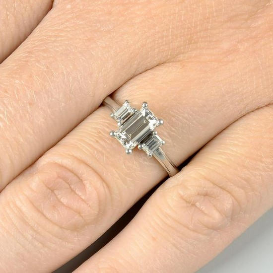 A baguette-cut diamond three-stone ring. Principal
