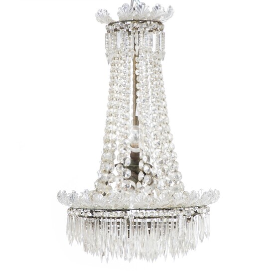 A crystal chandelier, top and bottom with glass leaves. Mounted inside for electricity. C. 1900. H. 86 cm. Diam. 49 cm.