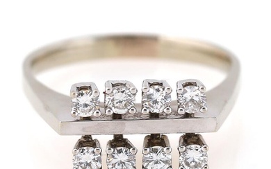 A diamond ring set with eight brilliant-cut diamonds, mounted in 18k white...