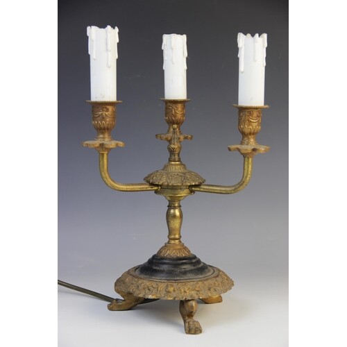 A gilt and ebonised metal three branch desk lamp, early 20th...
