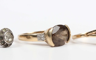 A gold, smoky quartz and diamond ring, mounted with an oval cut smoky quartz between diamond four st