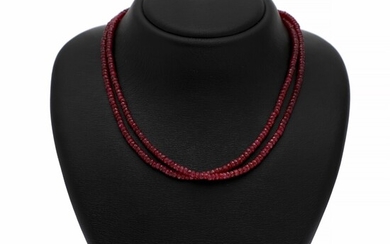 NOT SOLD. A graduated two-strand ruby necklace set with numerous roundel-cut rubies and a silver...