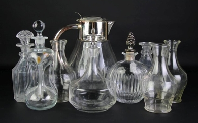 A group lot of glass decanters inc. one with metal acorn finial (9 pieces)