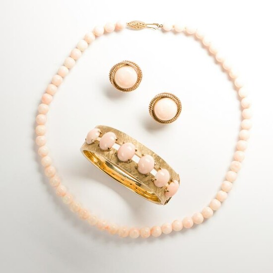 A group of angel skin coral and fourteen karat gold