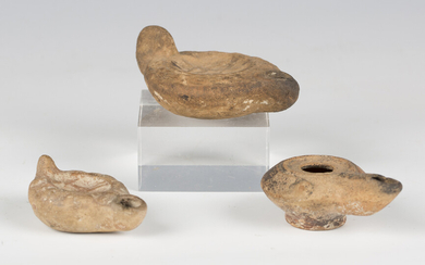 A group of three Roman terracotta oil lamps, one moulded with a horse, length 8cm.