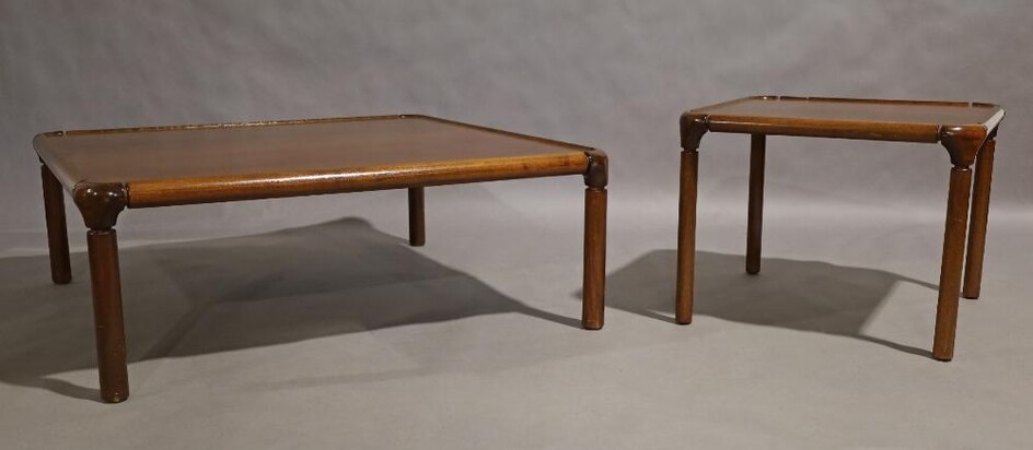 A large mahogany coffee table, 20th century, with rounded edges, raised on cylindrical supports, stamped 4069, 39cm high, 106cm wide, 106cm deep, together with a matching smaller example, stamped 4069, 47cm high, 61cm wide, 61cm deep (2)