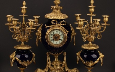 A late 19th century French gilt metal and porcelain clock ga...