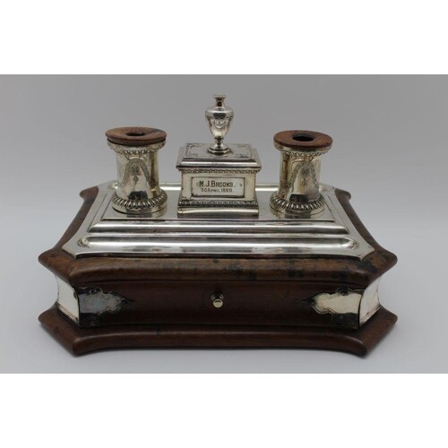 A late 19th century silver plate standish, fitted two inkwel...