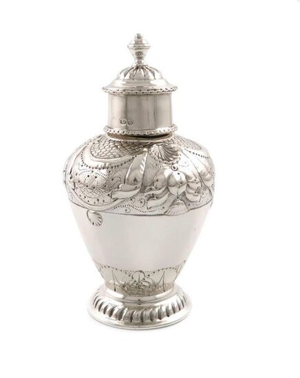 A late-Victorian silver tea canister, by Nathan and Hayes, Chester 1896, baluster form, embossed shell and drape decoration, pull-off cover with a knop finial, on a raised circular fluted foot, height 13.5cm, approx. weight 4.7oz.