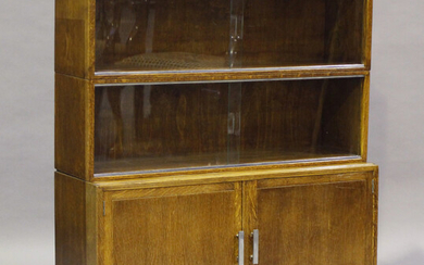 A mid-20th century oak three-section Minty bookcase with glass sliding doors, height 102cm, width 89
