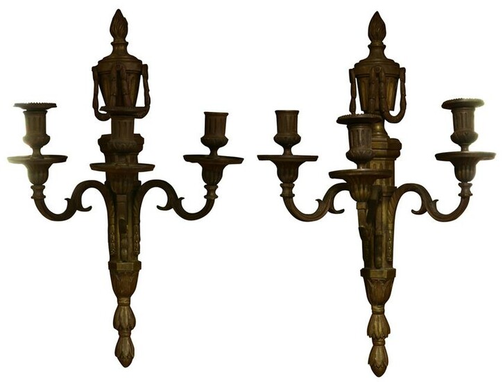 A pair of French Louis XVI patinated bronze sconces