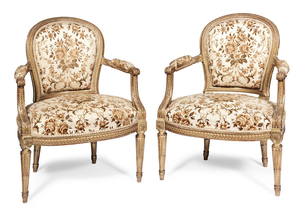 A pair of French late 19th century carved giltwood fauteuils by Jansen