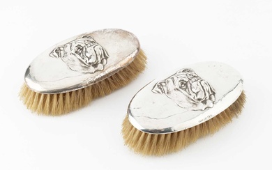 A pair of George V silver backed clothes brushes, each...
