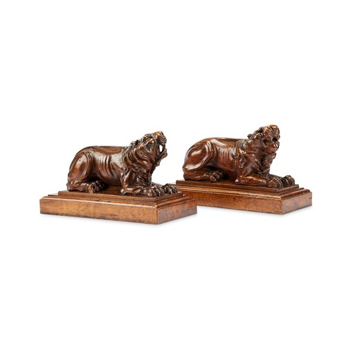 A pair of carved walnut recumbent lions, mid 19th century Ea...