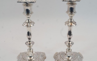 A pair of silver candlesticks, Sheffield, 1961, James Dixon & Sons, designed with knopped stems to shaped square feet with shell corners, bases filled, 22.7cm high, (pr)