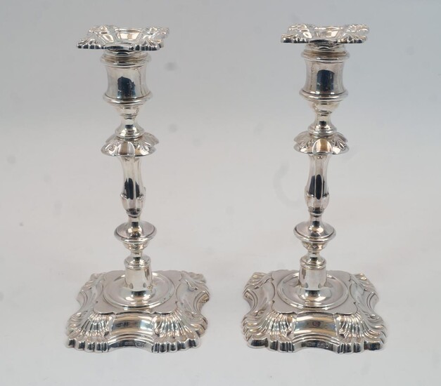 A pair of silver candlesticks, Sheffield, 1961, James Dixon & Sons, designed with knopped stems to shaped square feet with shell corners, bases filled, 22.7cm high, (pr)
