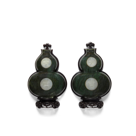 A pair of spinach jade 'double-gourd' wall hangings inlaid with white jade plaques