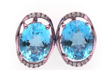 SOLD. A pair of topaz and diamond ear studs each set with an oval-cut topaz flanked by numerous brilliant-cut diamonds, mounted in 14k partly rose gilded white gold – Bruun Rasmussen Auctioneers of Fine Art