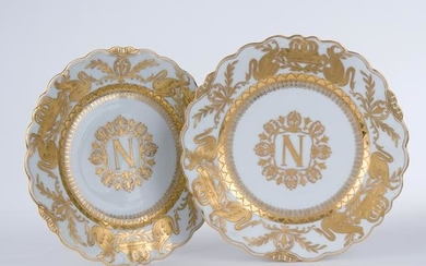 A pair of white and gilt porcelain plates