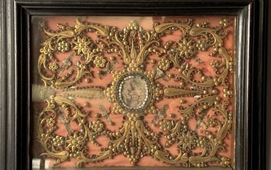 A reliquary frame decorated with gilded paper and...