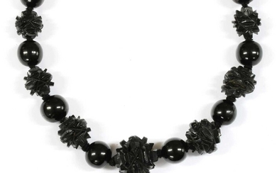 A single row graduated carved jet bead necklace