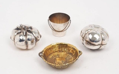 A small silver gilt basket by Tiffany & Co., London, 1959, 6.4cm dia., together with an egg cup designed as a bucket, stamped 925 and engraved with the letter 'A' to side, and two 800 standard Italian trinket boxes designed as tomatoes with hinged...