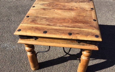 A square hardwood coffee table with hammered wrought iron nailed...