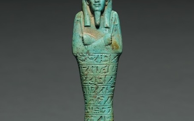 AN EGYPTIAN TURQUOISE FAIENCE USHABTI OF TJAI-NE-HEBU, ADMIRAL OF THE ROYAL FLEET, 26TH DYNASTY, REIGN OF AMASIS, 570-526 B.C.