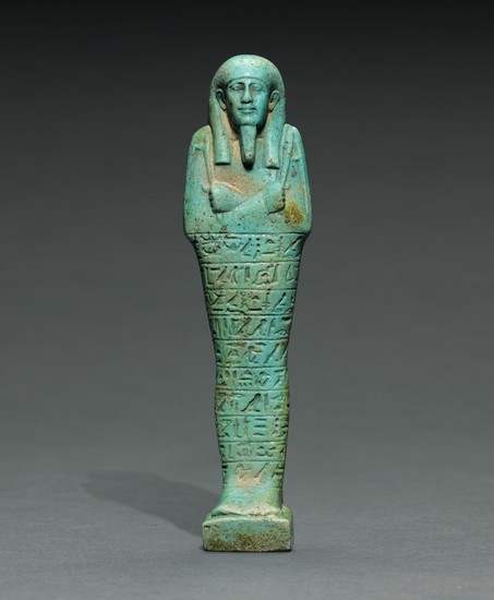 AN EGYPTIAN TURQUOISE FAIENCE USHABTI OF TJAI-NE-HEBU, ADMIRAL OF THE ROYAL FLEET, 26TH DYNASTY, REIGN OF AMASIS, 570-526 B.C.