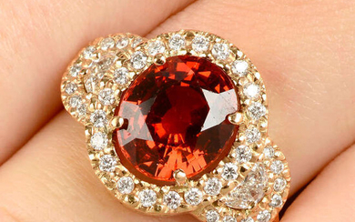 An 18ct gold spessartine garnet and diamond dress ring.