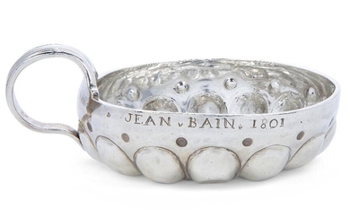 An 18th century French provincial silver wine taster, Tours, maker's mark I.B, of traditional form with tapering reeded handle, the rim scratch engraved 'JEAN BAIN 1801', 8.7cm dia., approx. weight 4.1oz Provenance: Works of Art from the Schroder...