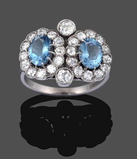 An Aquamarine and Diamond Double Cluster Ring, two oval cut aquamarines in white claw settings...