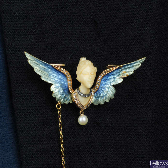An Art Nouveau gold, carved ivory female bust brooch, with enamel and diamond wings, suspending a pearl.