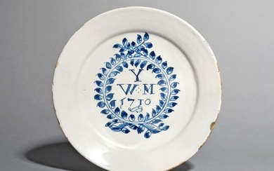 An English delftware plate dated 1710, inscribed in...