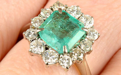 An emerald and circular-cut diamond cluster ring.