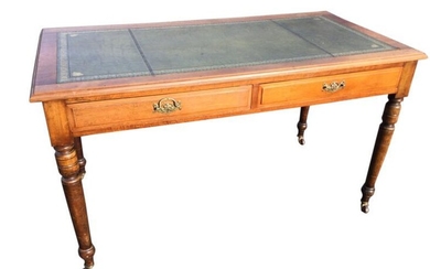 An late Victorian mahogany writing desk with gilt tooled...