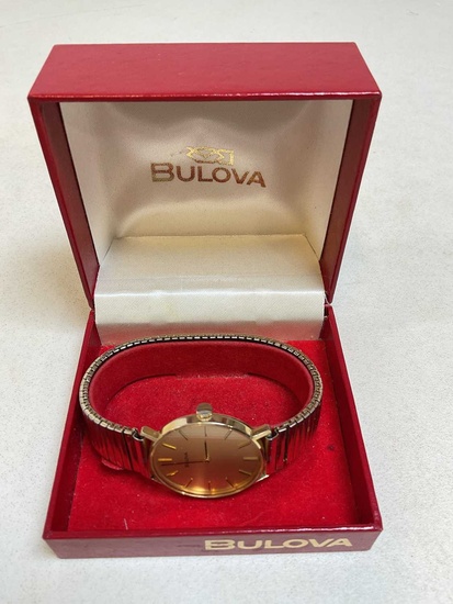 BULOVA; a vintage 9ct yellow gold wristwatch with gold baton...