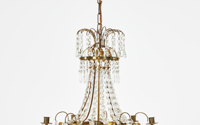 CHANDELIER. Empire style, mid 20th century, five brass light arms, different cut prisms, interior with mounted light sources.