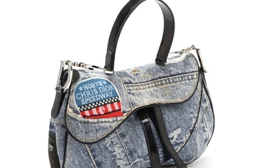 NOT SOLD. Christian Dior: A "Denim Saddle Bag" of denim print canvas with one large...