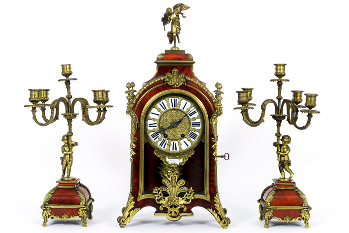 FLINOIS TROUILLE (AMIENS) three-part antique fireplace set in Louis XV - style with tortoise and decorated bronze and consisting of a pair of candlesticks with amour (44,5 cm high) and a knurled clock (61 cm high) with work signed "Vincenti & Cie -...