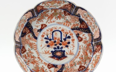 JAPANESE IMARI PORCELAIN DISH In six-lobed form, with decoration of a flower basket at center. Diameter 10".