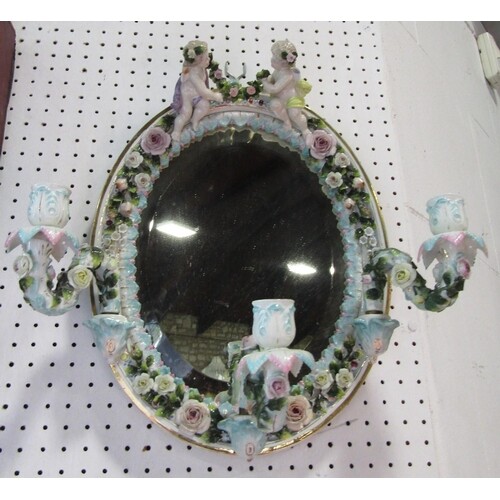 Late 19th century German porcelain mirror, oval, surmounted ...