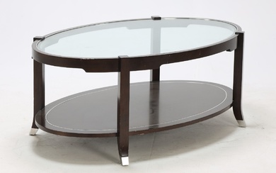 Oval coffee table of dark stained wood with glass top