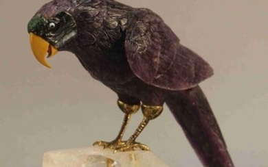 STATUETTE of parrot in amethyst, hard stones and gilt bronze, perched on a rock crystal base. In the style of Fabergé. Height : 24 cm